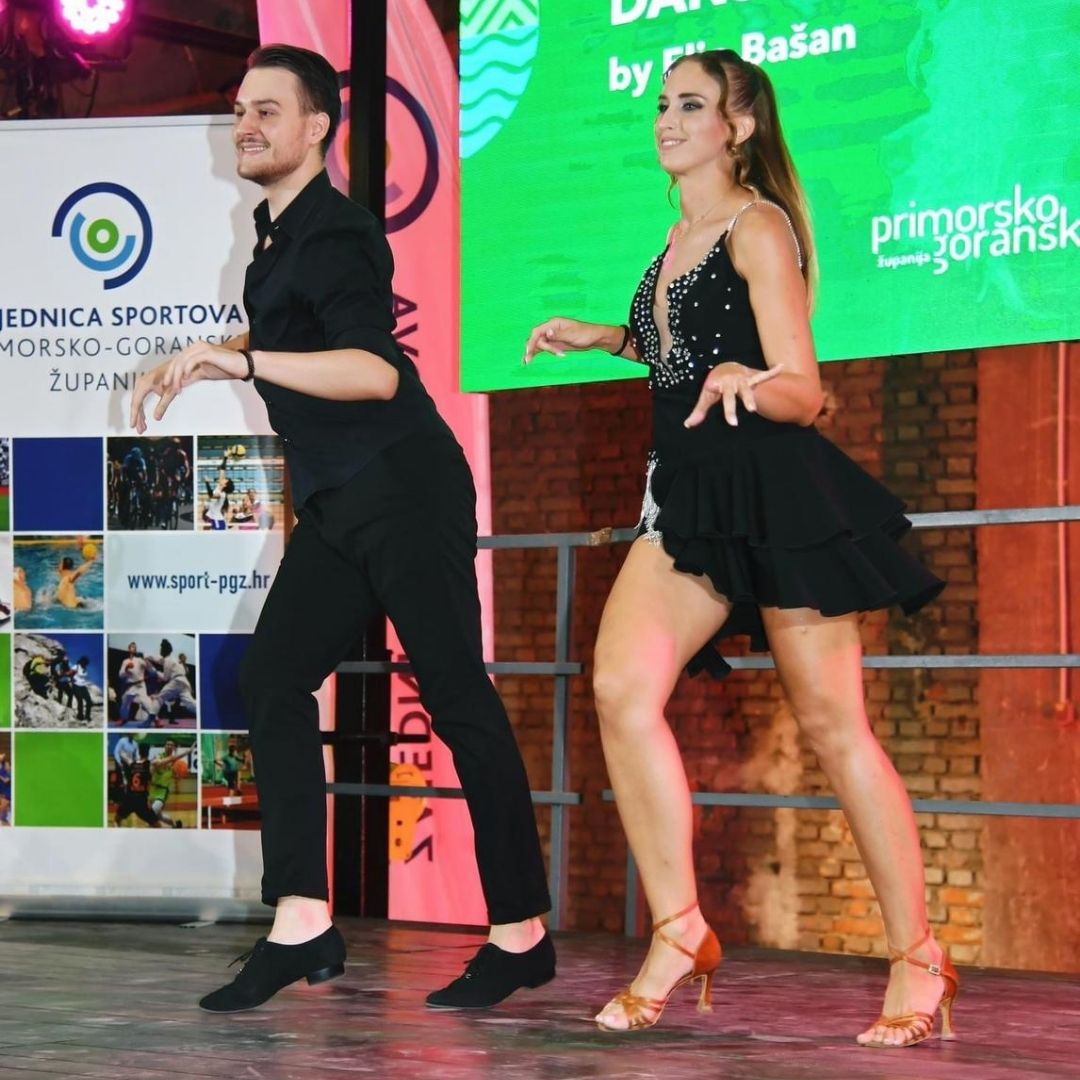 Two dancers on a dance floor, dancing for social media content.